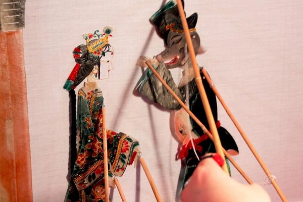 learning Chinese puppetry in Guilin as part of a cultural heritage tour for students